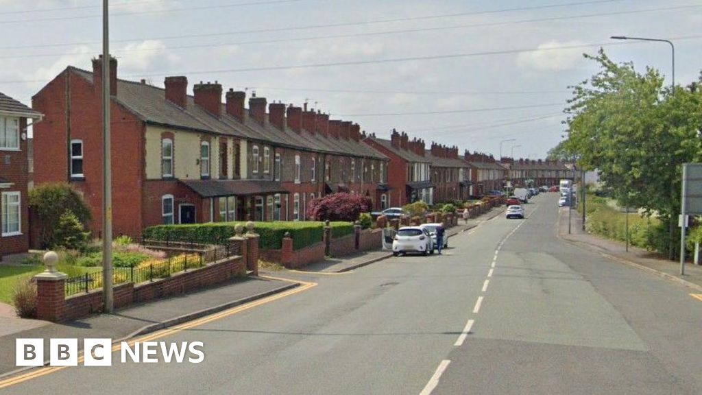 Pair struck and hurt by police vehicle in Wigan