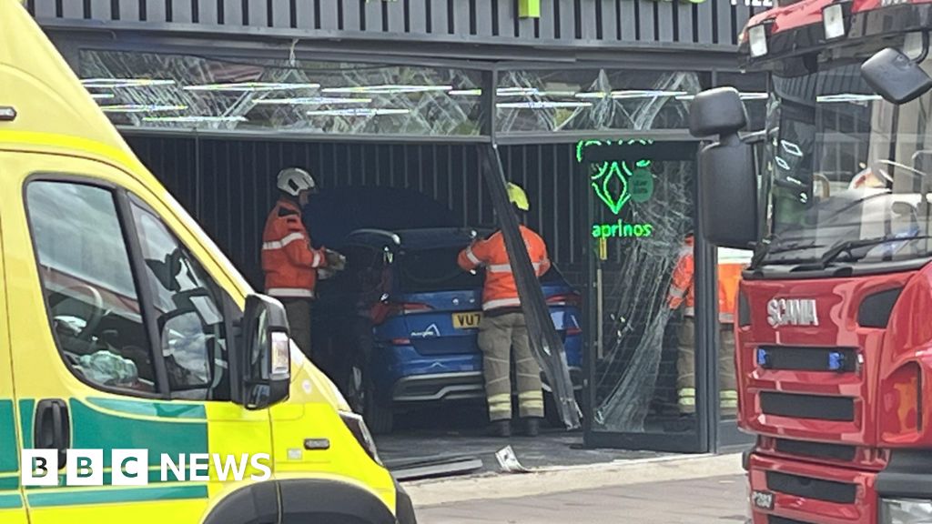 Road closed after car crashes into Gloucester pizza shop