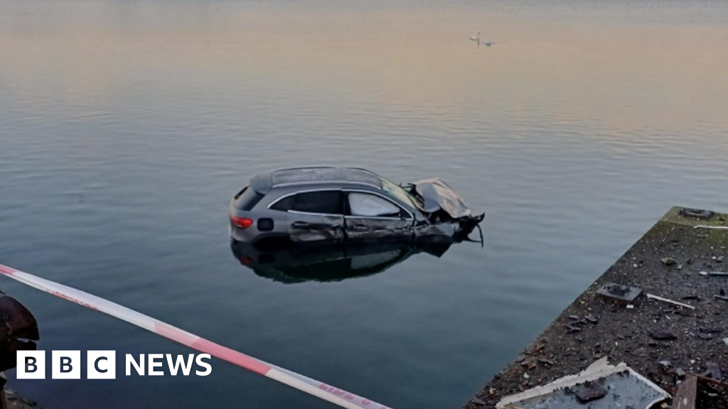 Car destroys listed building and sinks in lake after police chase