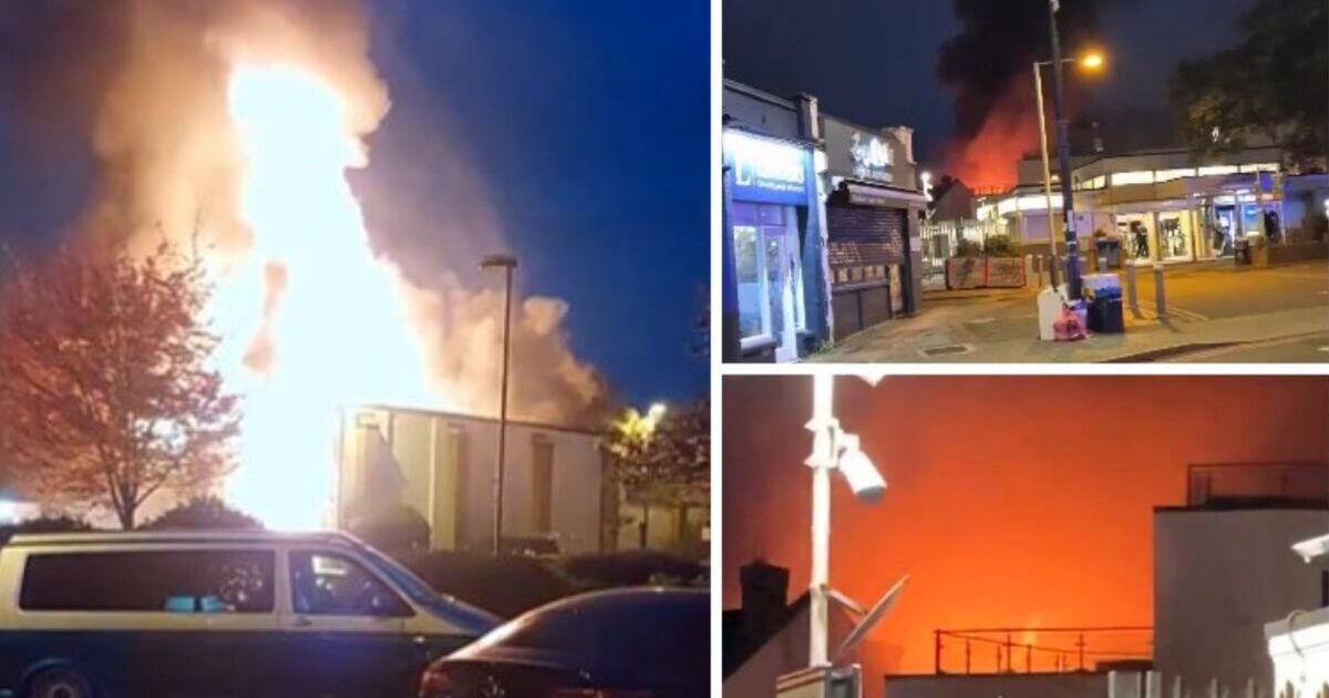 Huge fire erupts near train station with 100 firefighters tackling the blaze