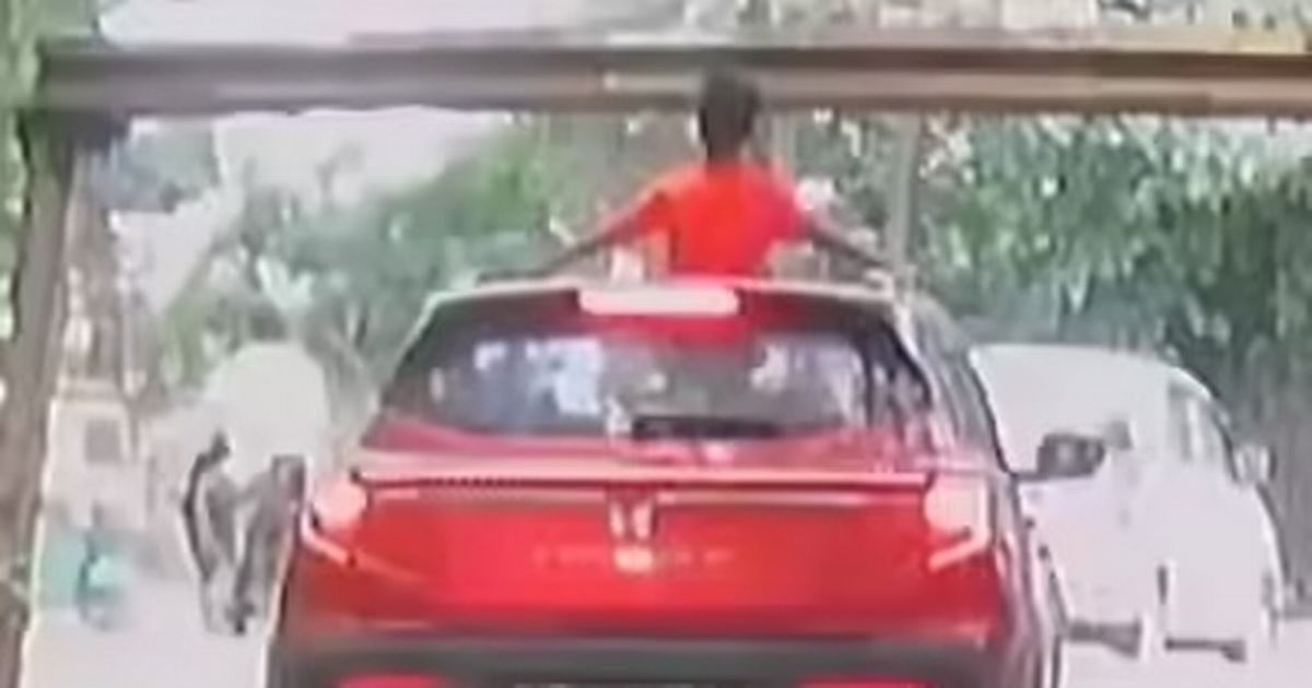 Boy, 6, hangs out of sunroof then bashes head on barrier in appalling video - The Mirror