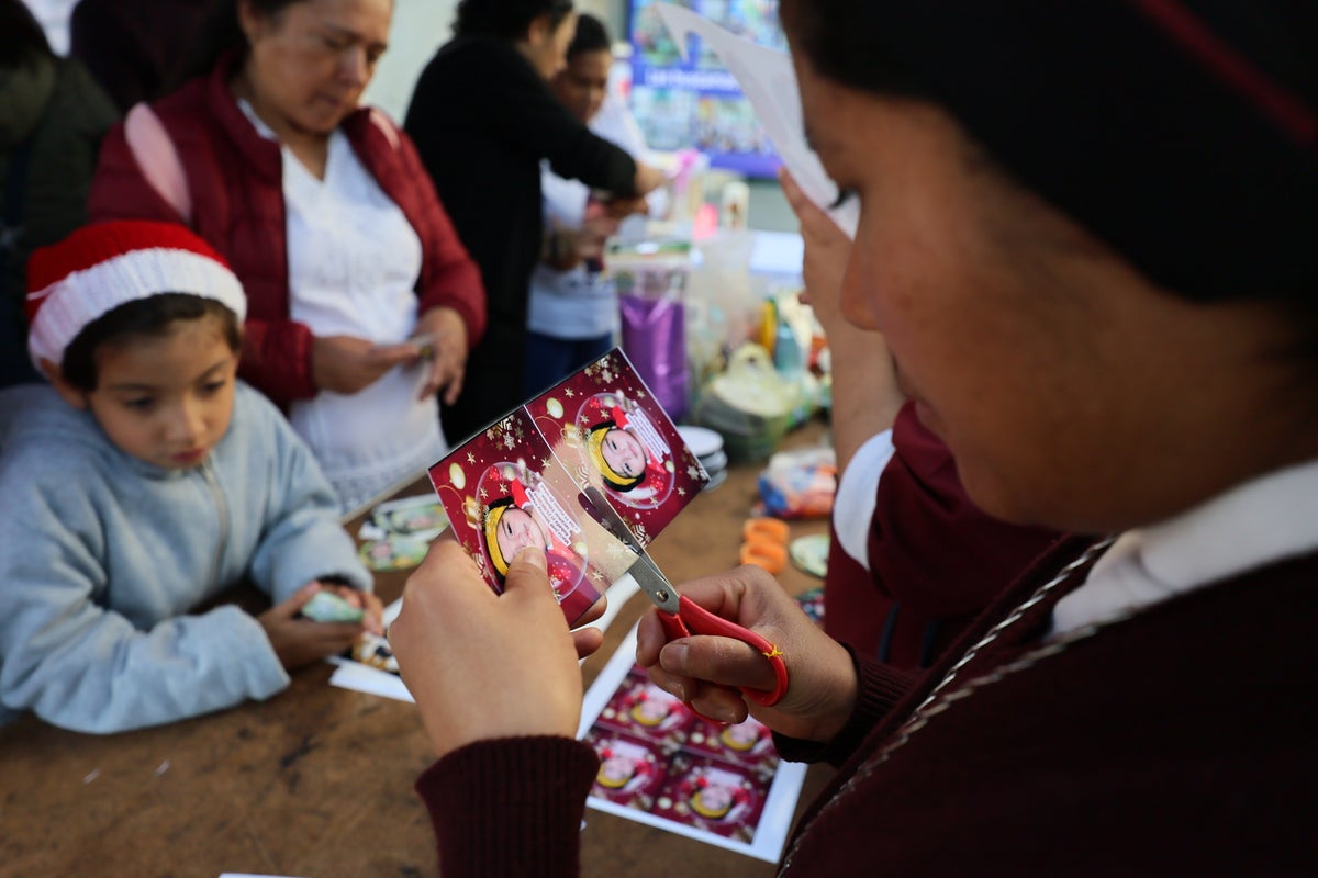 A Christmas tree in Mexico carries the faces of loved ones who never came home