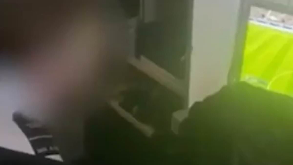 Moment prison officer is filmed playing computer game with a criminal