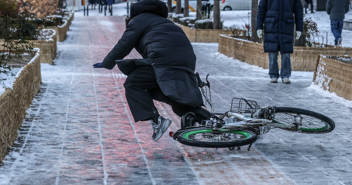 Cyclist Loses Balance as Front Wheel Hits Icy Patch