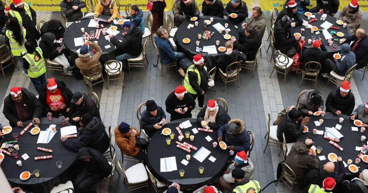 Hundreds of homeless people pack into city train station for Christmas Eve feast