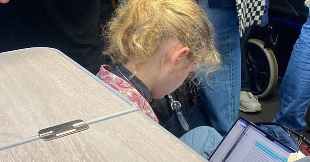 Princess Louise Windsor Sits on Train Floor Amid Crowd
