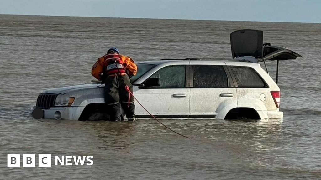 Car stuck in the sea at Greatstone after being driven over protected dunes