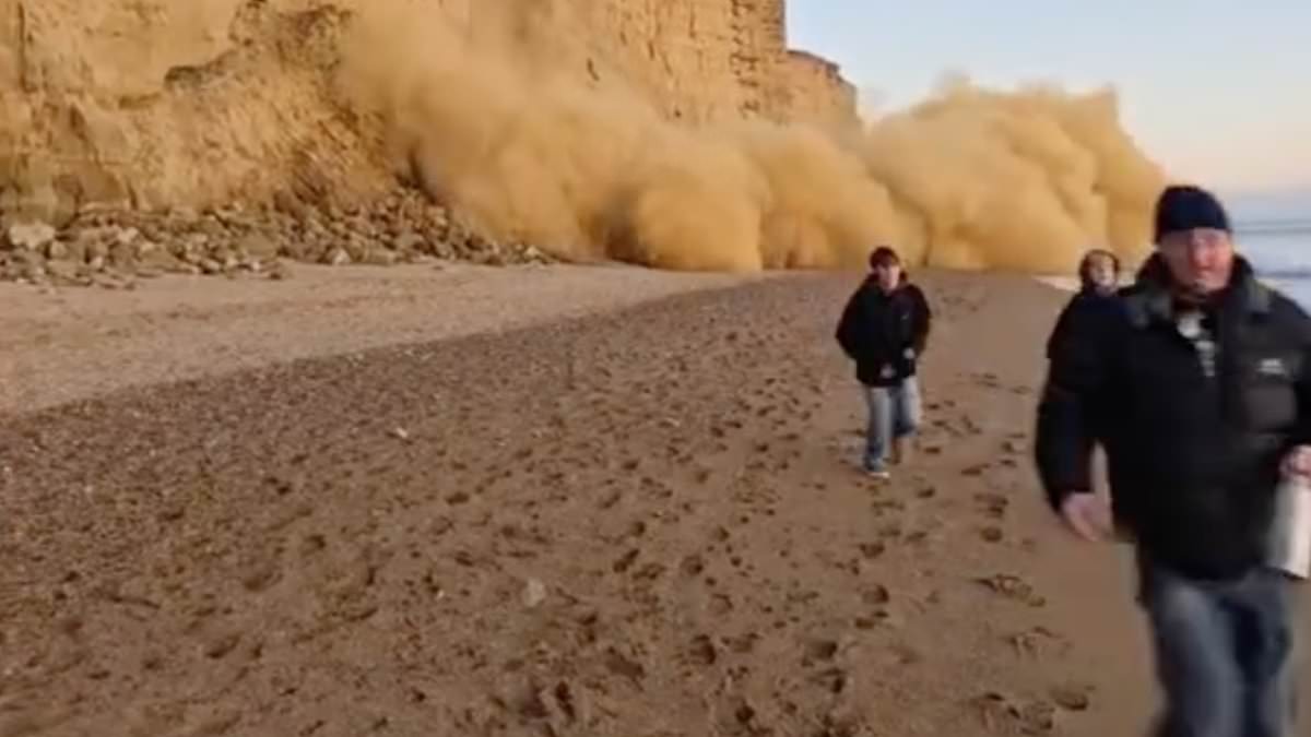 Moment beach walkers run for their lives as a cliff crumbles
