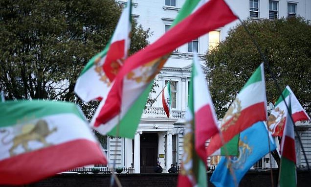 Protester put pre-Islamic revolution Iran flag on London embassy:...