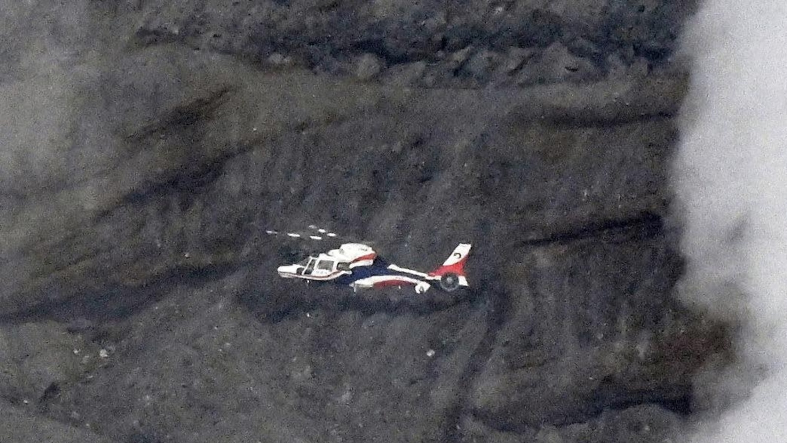 Rescuers spot wreckage possibly from a helicopter that went missing near a volcano in Japan