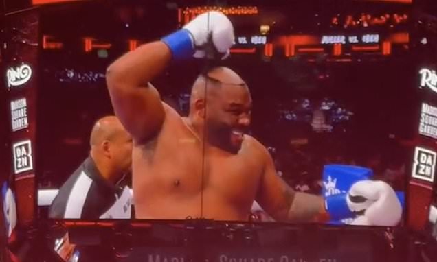 Shocking moment boxer's hair piece falls off as he gets pummeled